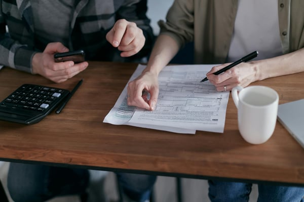 man and woman signing papers